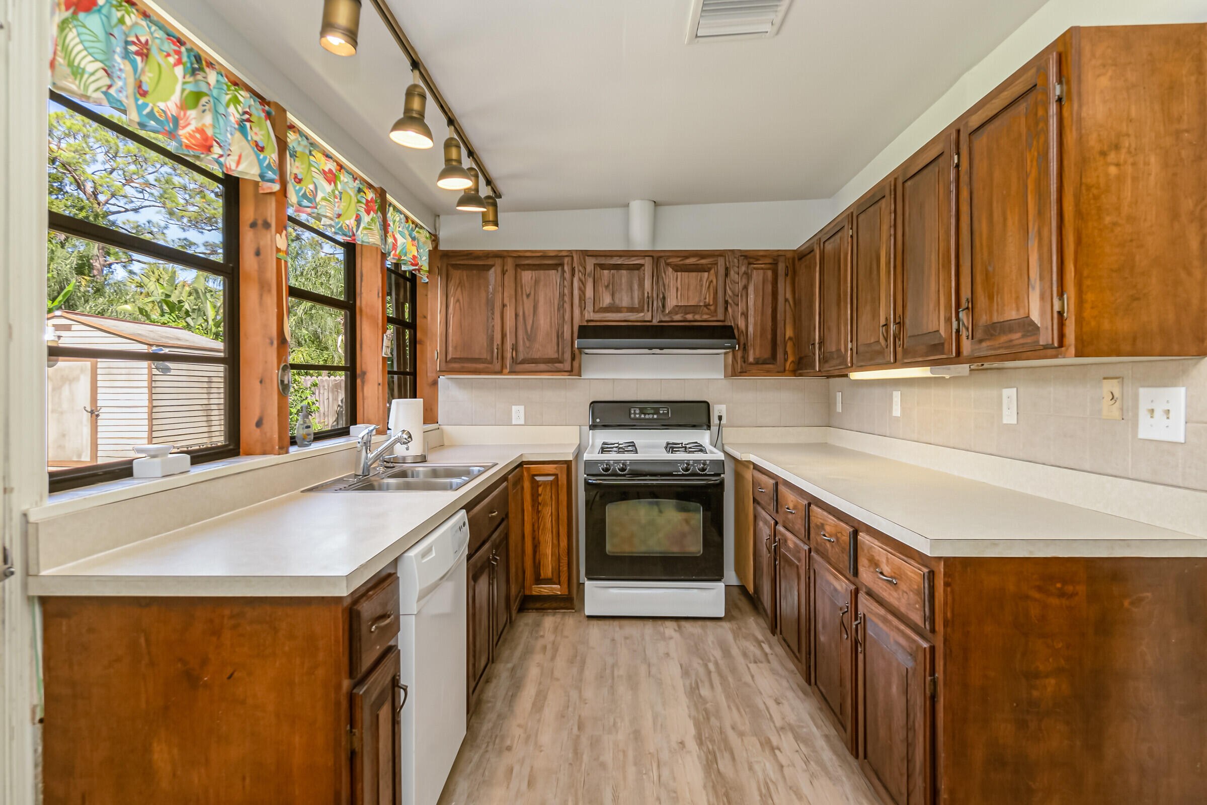 1106 Woodlawn Road Rockledge, FL 32955 - Photo 9 of 57 a kitchen with kitchen island granite countertop a sink appliances and cabinets
