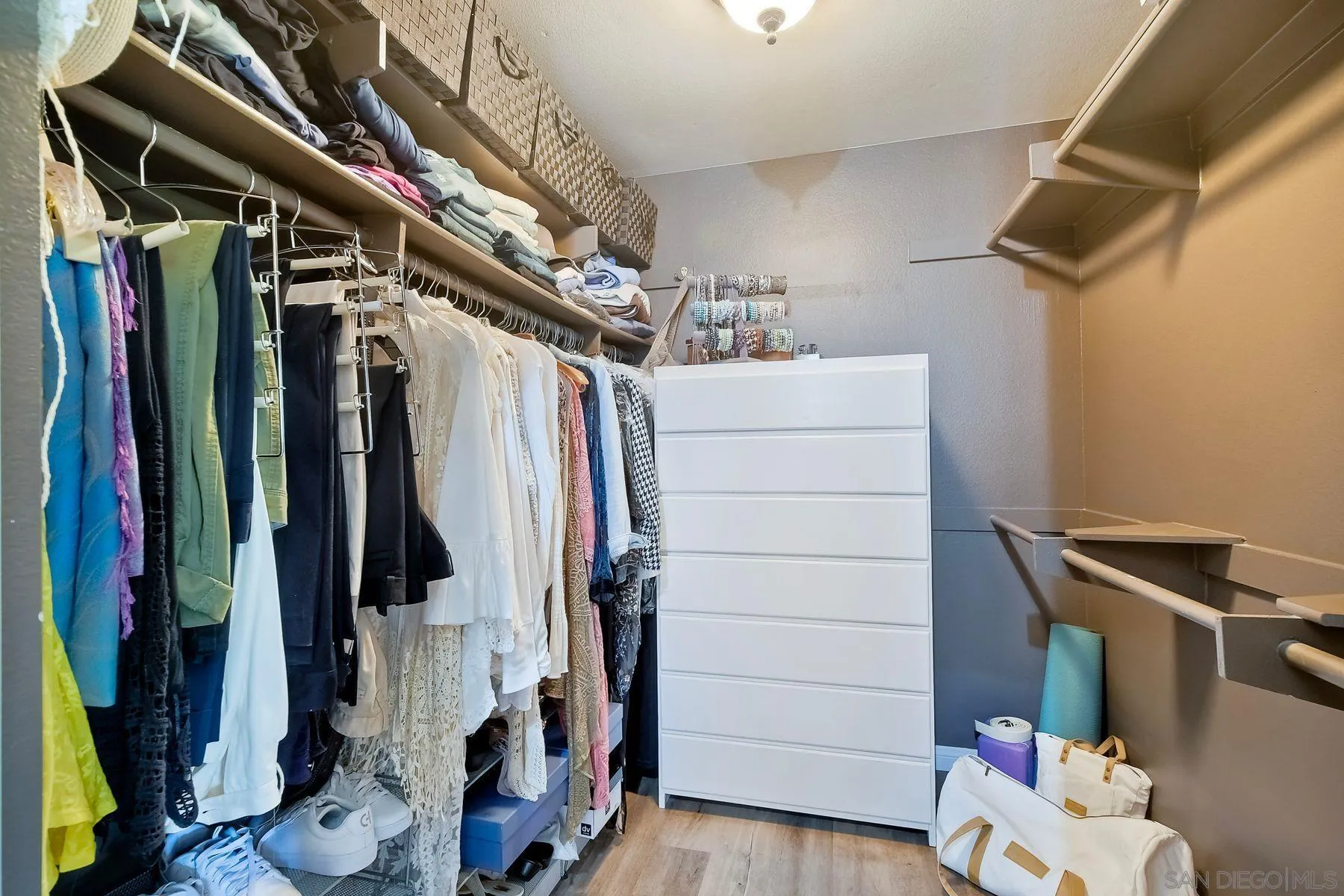 11467 Box Elder Place San Diego, CA 92127 - Photo 23 of 31 a view of walk in closet with clothes and shoes