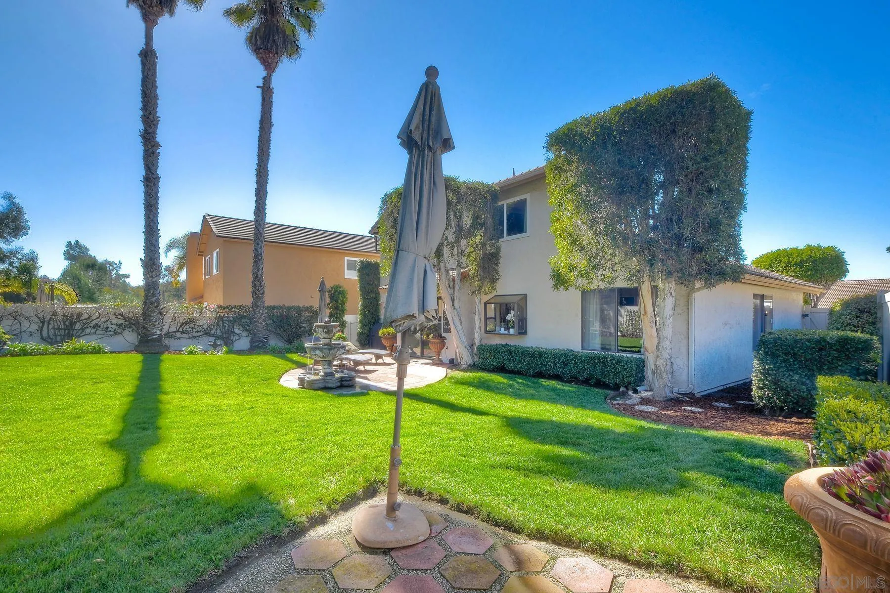 11467 Box Elder Place San Diego, CA 92127 - Photo 29 of 31 a view of a garden with a tree in front of the house