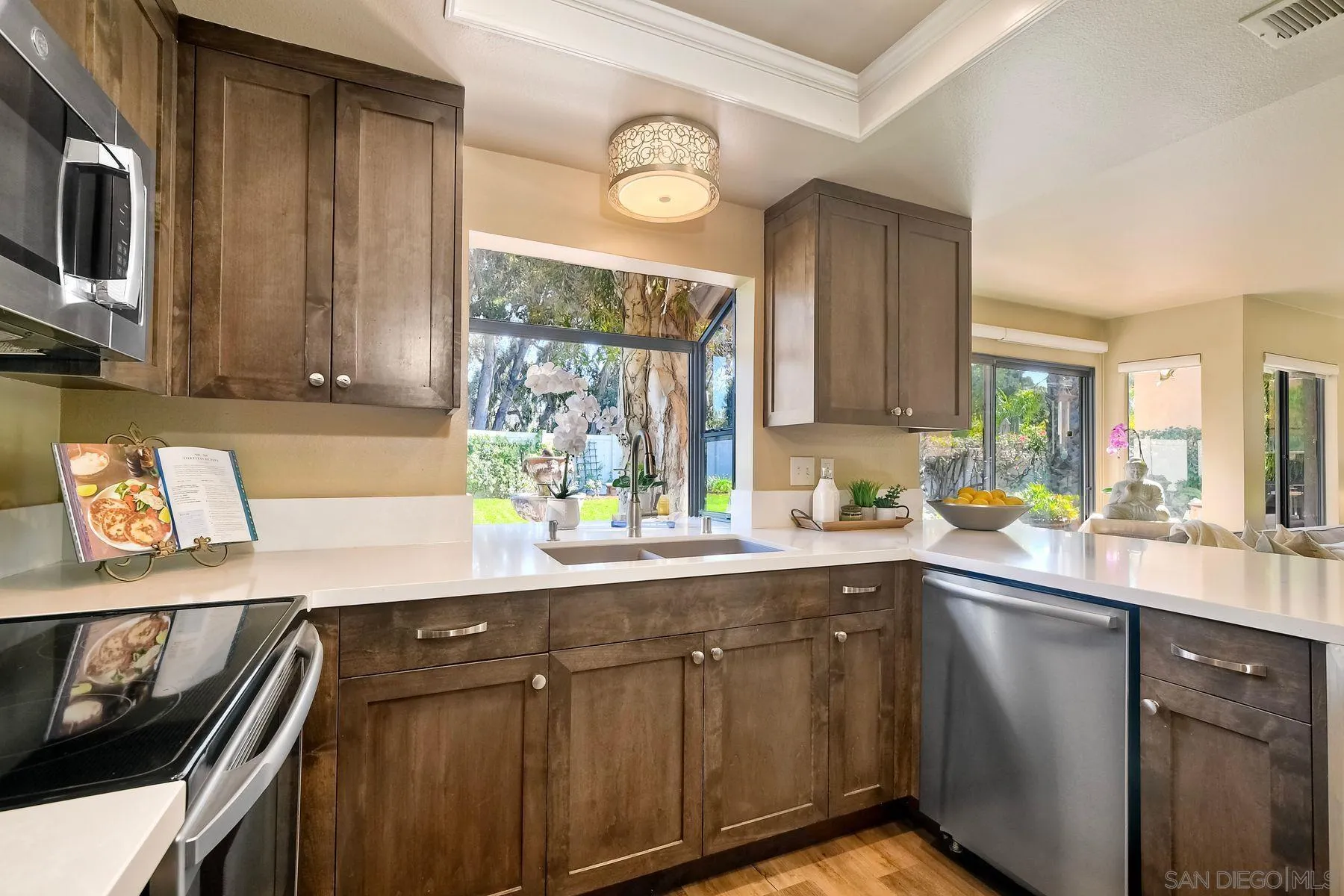 11467 Box Elder Place San Diego, CA 92127 - Photo 9 of 31 a kitchen with stainless steel appliances a sink a stove and a window