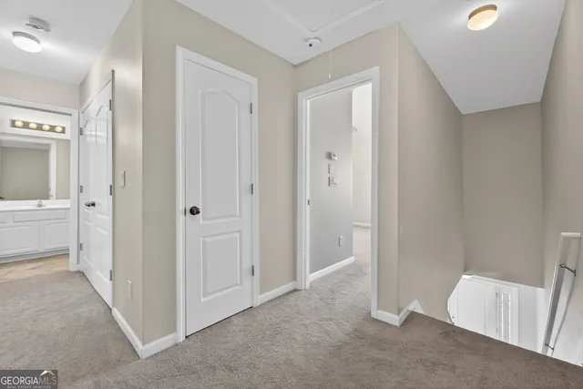 a view of a room with a sink and mirror