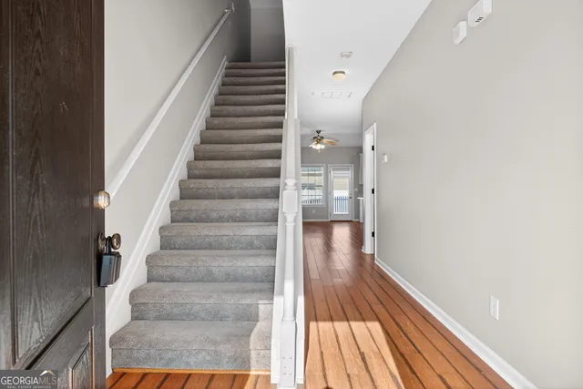 a view of entryway and gallery with wooden floor