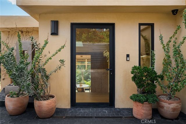 a table and chair with potted plants