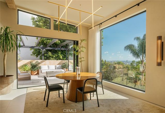 a view of a dining room with furniture window and outside view