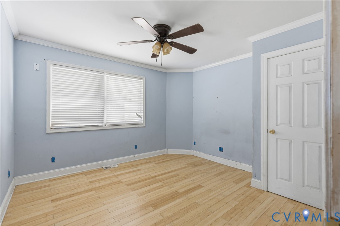 6106 Lewis Road Petersburg, VA 23803 - Photo 11 of 29 a view of empty room with wooden floor and ceiling fan
