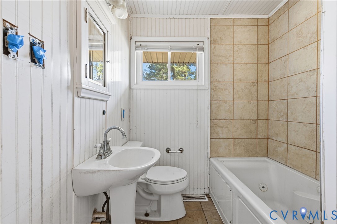 6106 Lewis Road Petersburg, VA 23803 - Photo 13 of 29 a bathroom with a sink toilet and shower