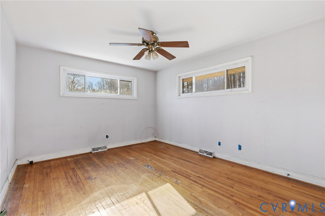 6106 Lewis Road Petersburg, VA 23803 - Photo 14 of 29 a view of a room with wooden floor and ceiling fan