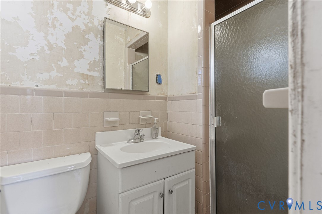 6106 Lewis Road Petersburg, VA 23803 - Photo 16 of 29 a bathroom with a sink a toilet and shower