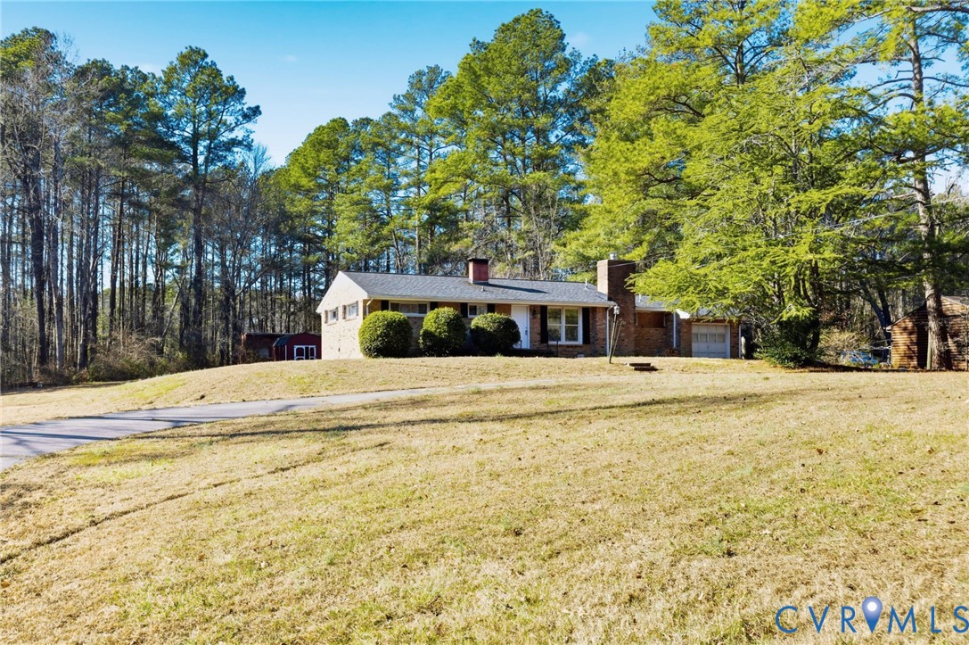 6106 Lewis Road Petersburg, VA 23803 - Photo 3 of 29 a view of house with outdoor space and trees in the background
