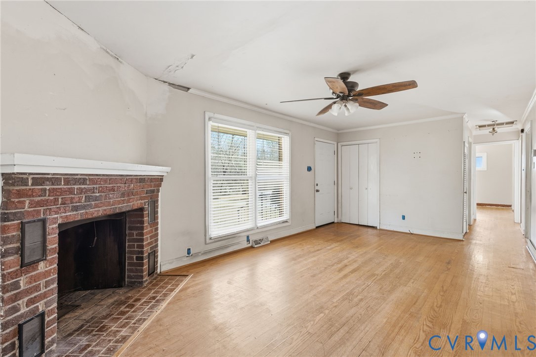 6106 Lewis Road Petersburg, VA 23803 - Photo 6 of 29 wooden floor fireplace and windows in an empty room