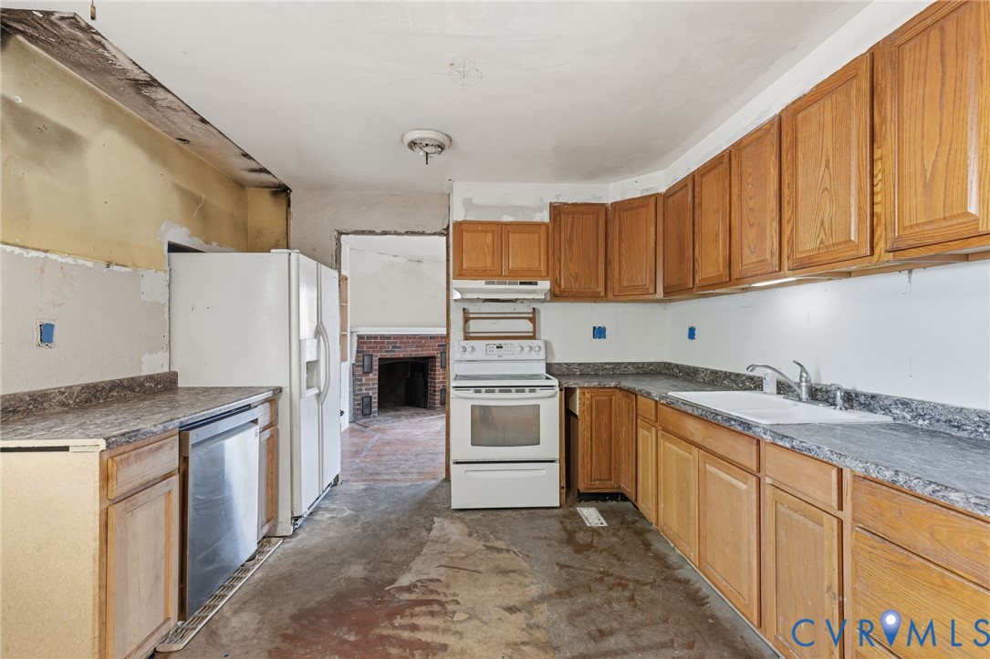 6106 Lewis Road Petersburg, VA 23803 - Photo 7 of 29 a kitchen with stainless steel appliances granite countertop a refrigerator sink and cabinets