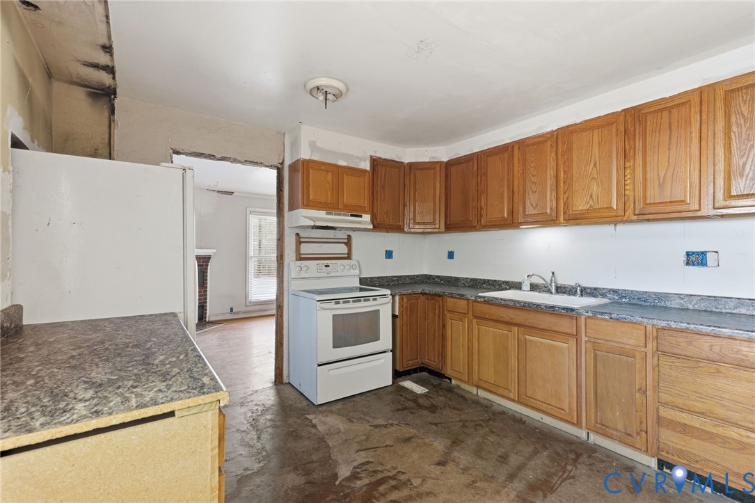 6106 Lewis Road Petersburg, VA 23803 - Photo 8 of 29 a kitchen with granite countertop a sink stove and refrigerator