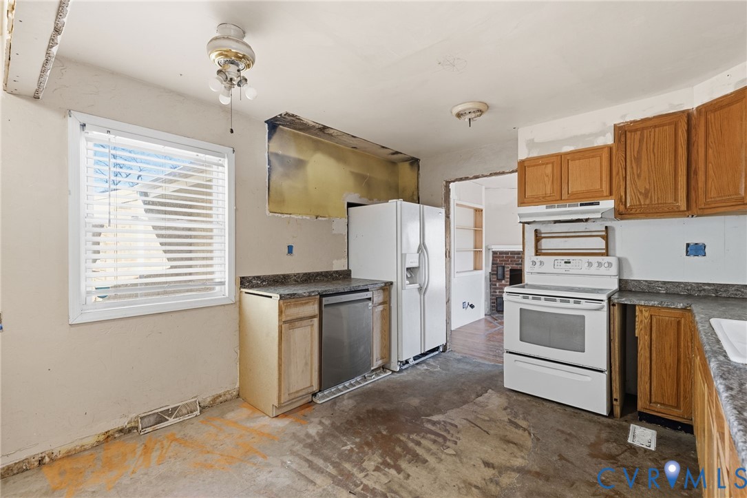 6106 Lewis Road Petersburg, VA 23803 - Photo 9 of 29 a kitchen with a refrigerator stove and a sink