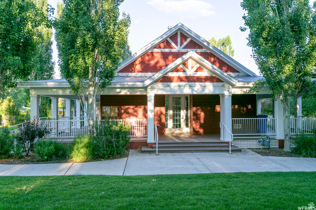 557 Craftsman Way Midway, UT 84049 - Photo 57 of 59 Red-sided building featuring a covered porch, white trim, and a gabled roof