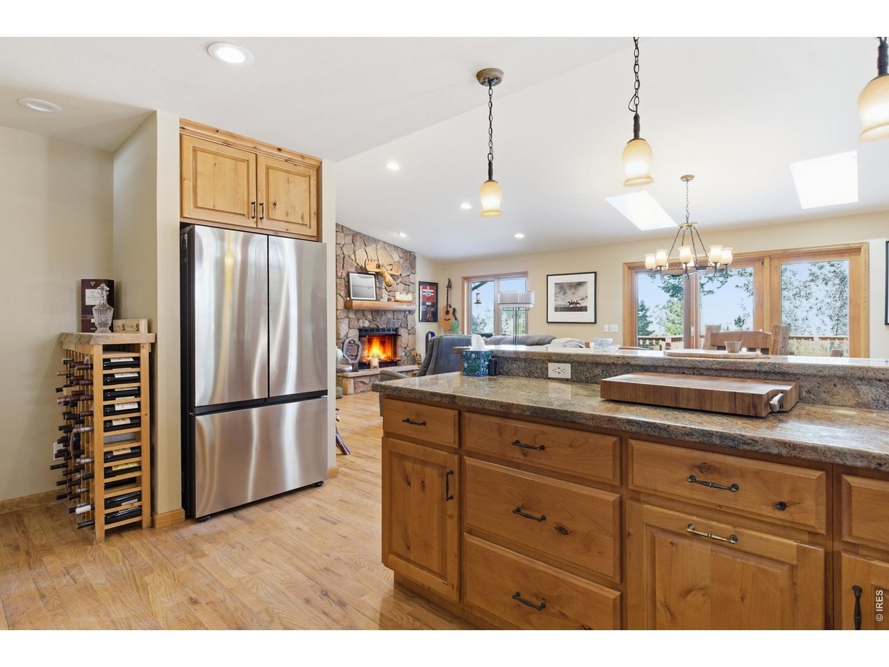 4079 Little Valley Road Estes Park, CO 80517 - Photo 16 of 39 a kitchen with a refrigerator a sink and dishwasher with wooden floor