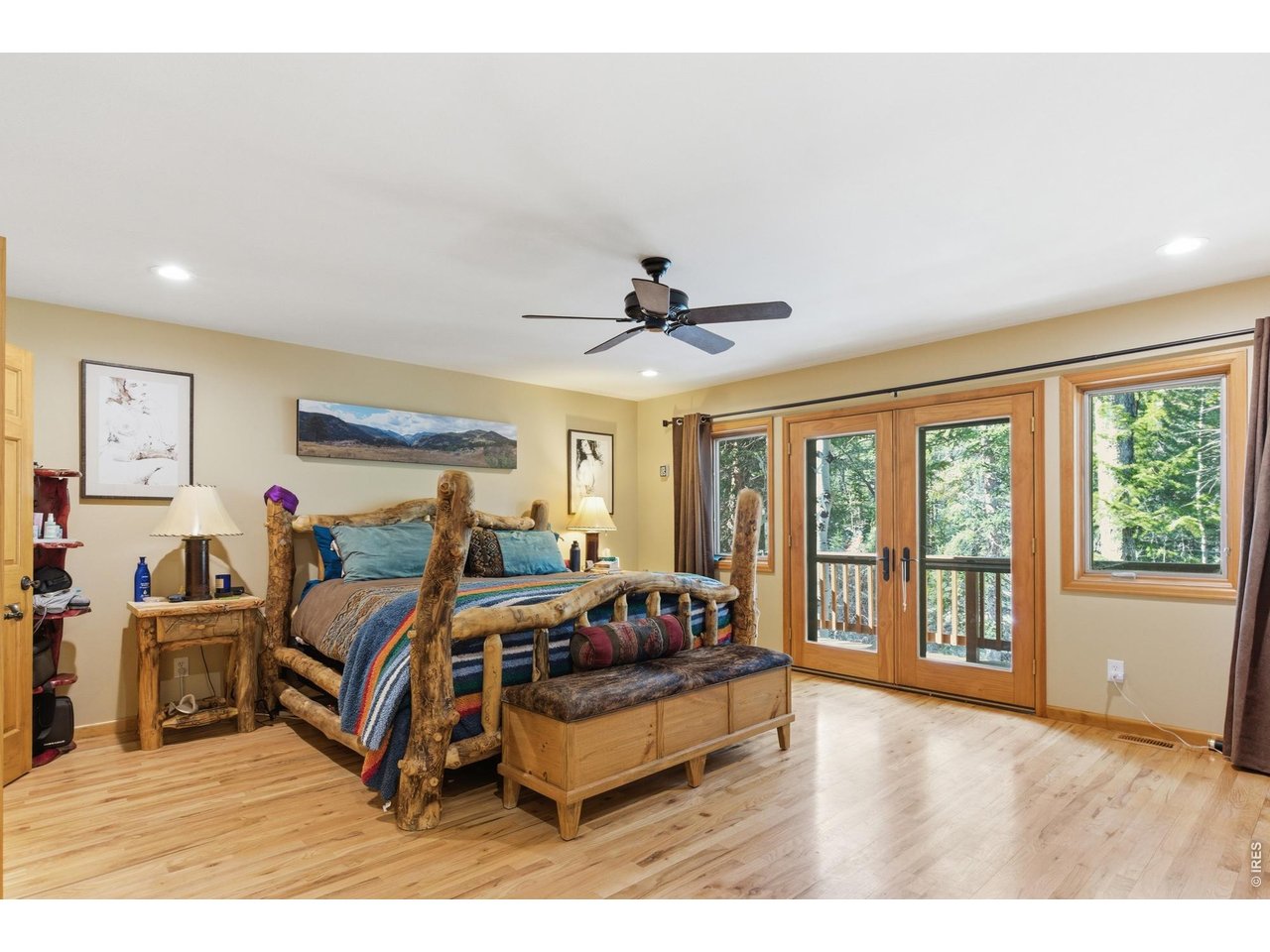 4079 Little Valley Road Estes Park, CO 80517 - Photo 20 of 39 a spacious bedroom with a bed and a large window