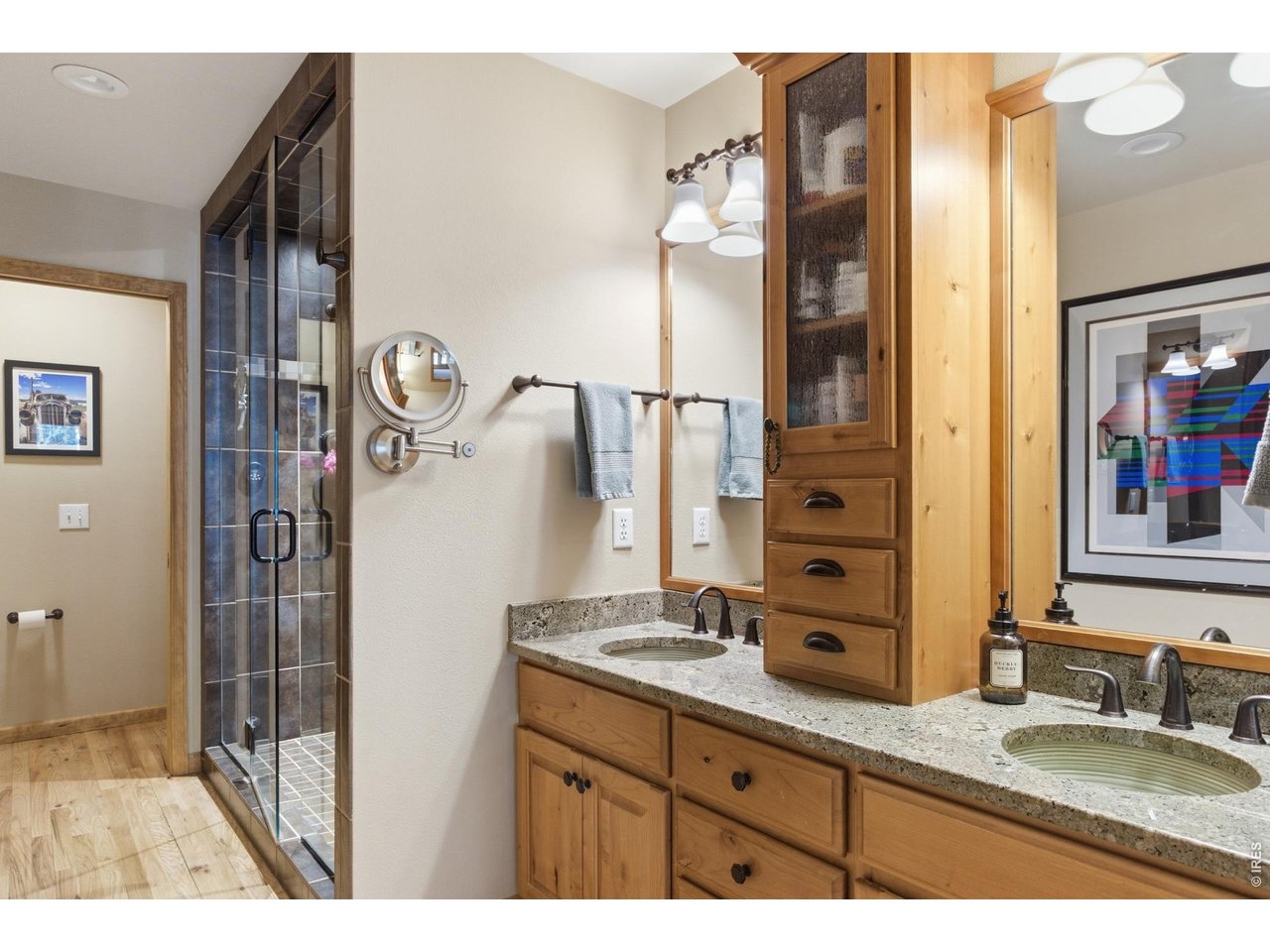 4079 Little Valley Road Estes Park, CO 80517 - Photo 21 of 39 a bathroom with a granite countertop sink a mirror and shower