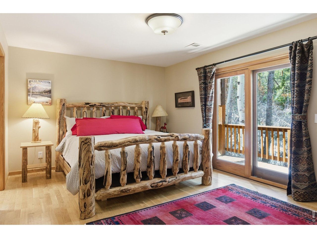 4079 Little Valley Road Estes Park, CO 80517 - Photo 28 of 39 a bedroom with a bed with wooden floor