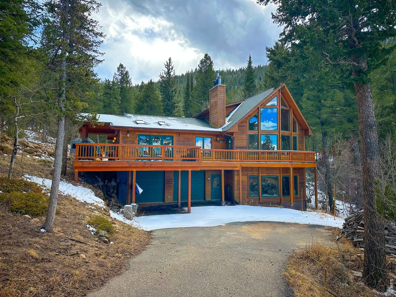 4079 Little Valley Road Estes Park, CO 80517 - Photo 38 of 39 front view of a house with a large window