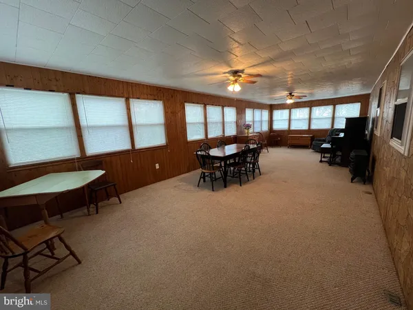 a view of a livingroom with furniture and a window