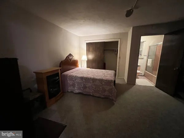 a bedroom with a bed and a mirror