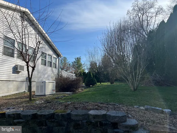 a big yard with lots of green space and plants