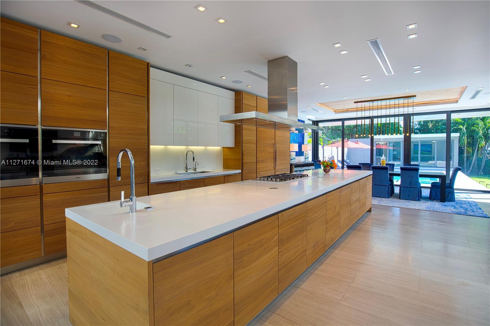 5061 North Bay Road Miami Beach, FL 33140 - Photo 5 of 23 a large kitchen with stainless steel appliances a large counter top