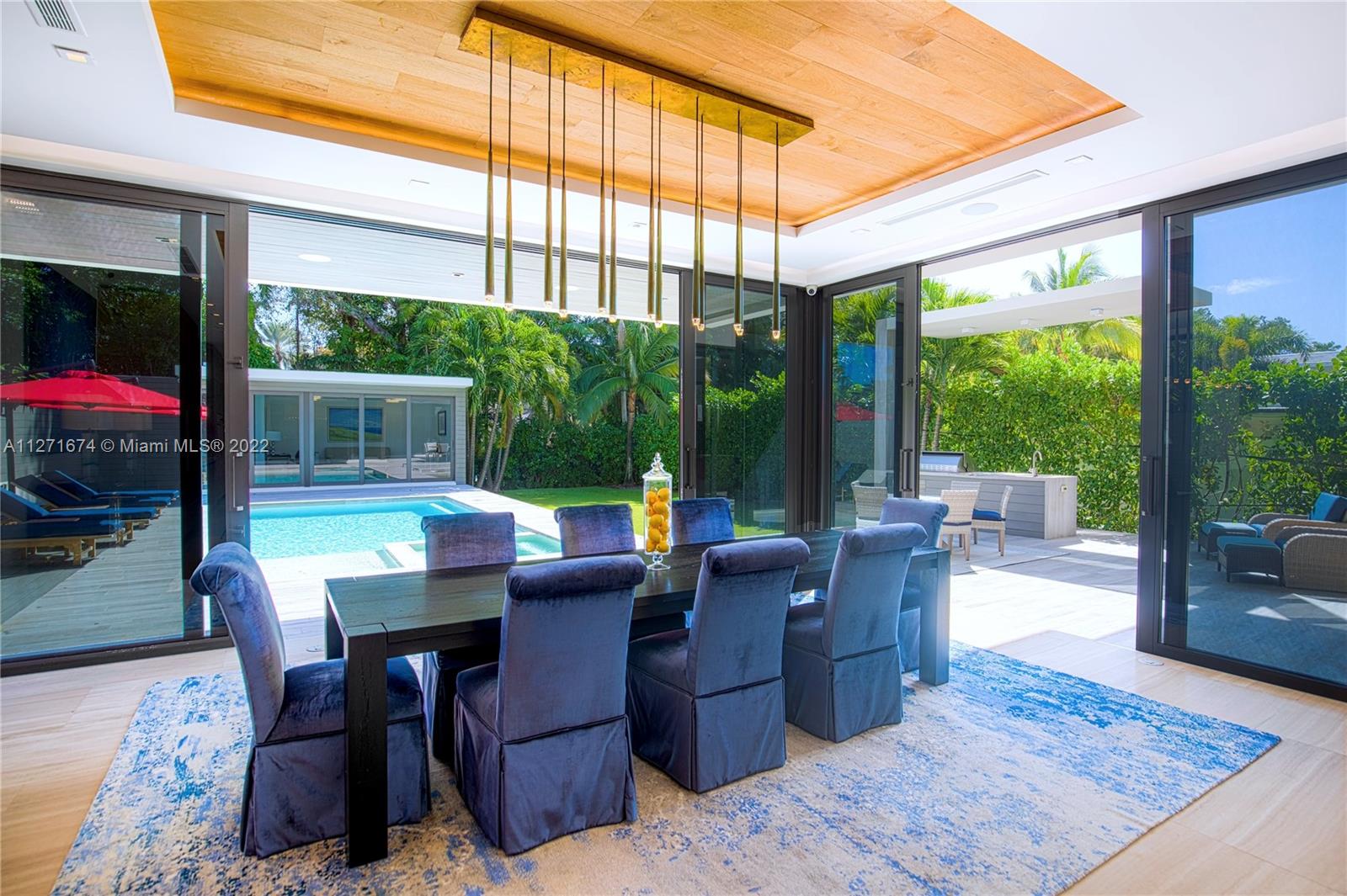 5061 North Bay Road Miami Beach, FL 33140 - Photo 6 of 23 a dining room with furniture and a floor to ceiling window