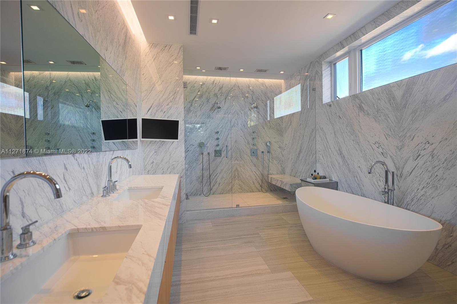 5061 North Bay Road Miami Beach, FL 33140 - Photo 8 of 23 a spacious bathroom with a bathtub and shower