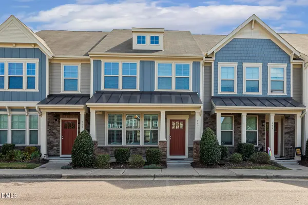 front view of a brick building next to a yard