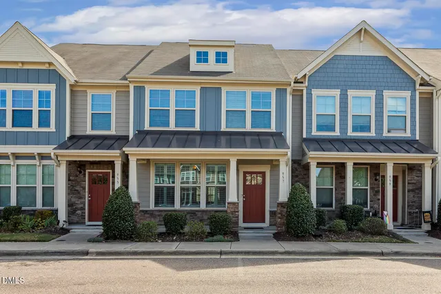 front view of a brick building next to a yard