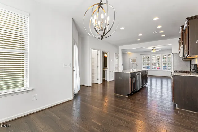 an open space with kitchen view and a refrigerator