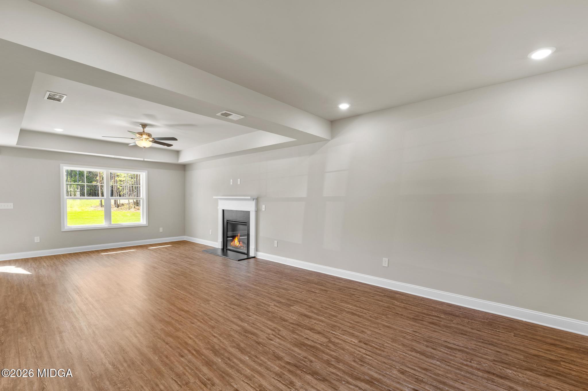 220 Welsh Trail Macon, GA 31216 - Photo 11 of 30 a view of an empty room with wooden floor and a window