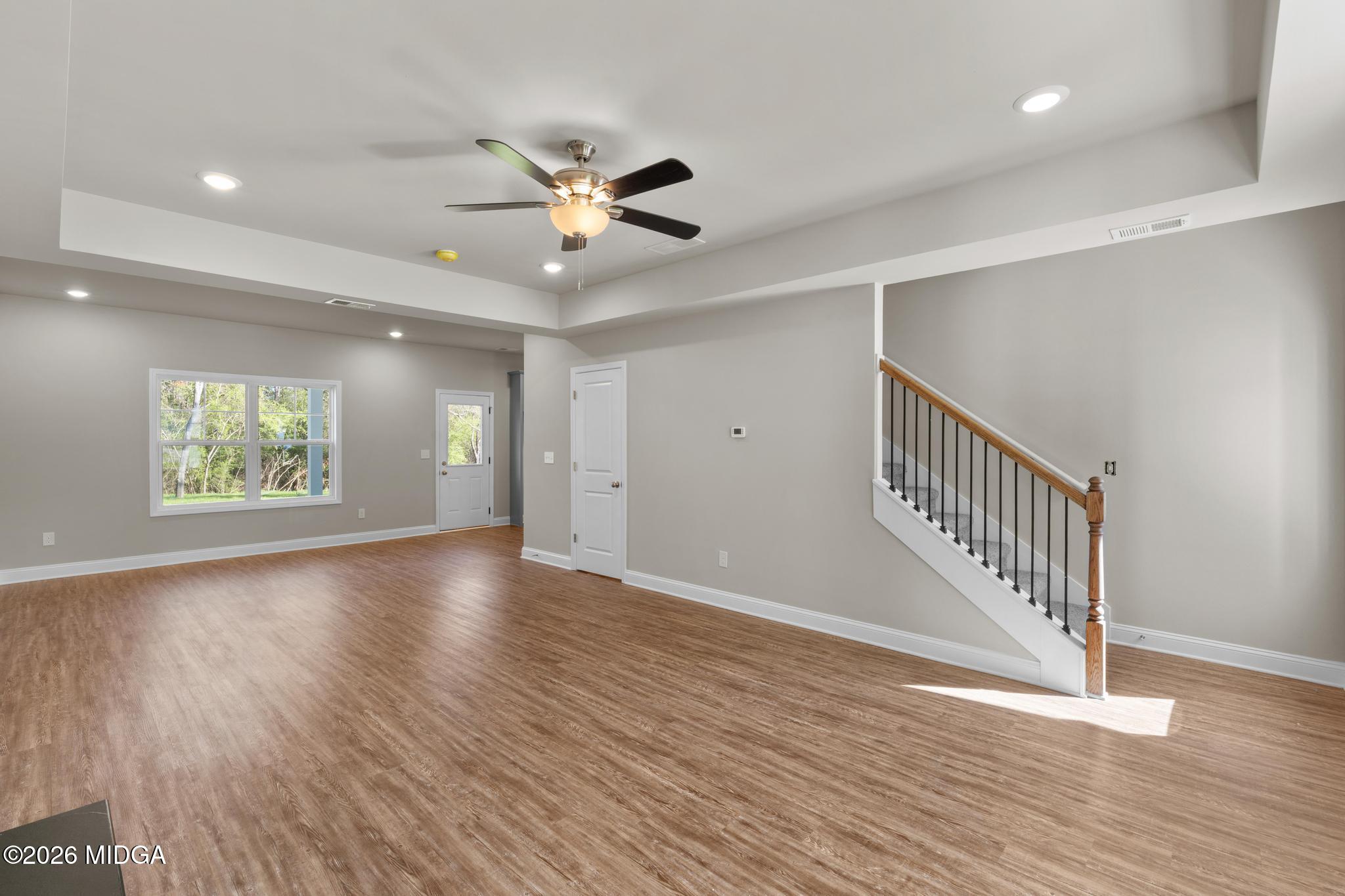 220 Welsh Trail Macon, GA 31216 - Photo 13 of 30 a view of an empty room with wooden floor and a window