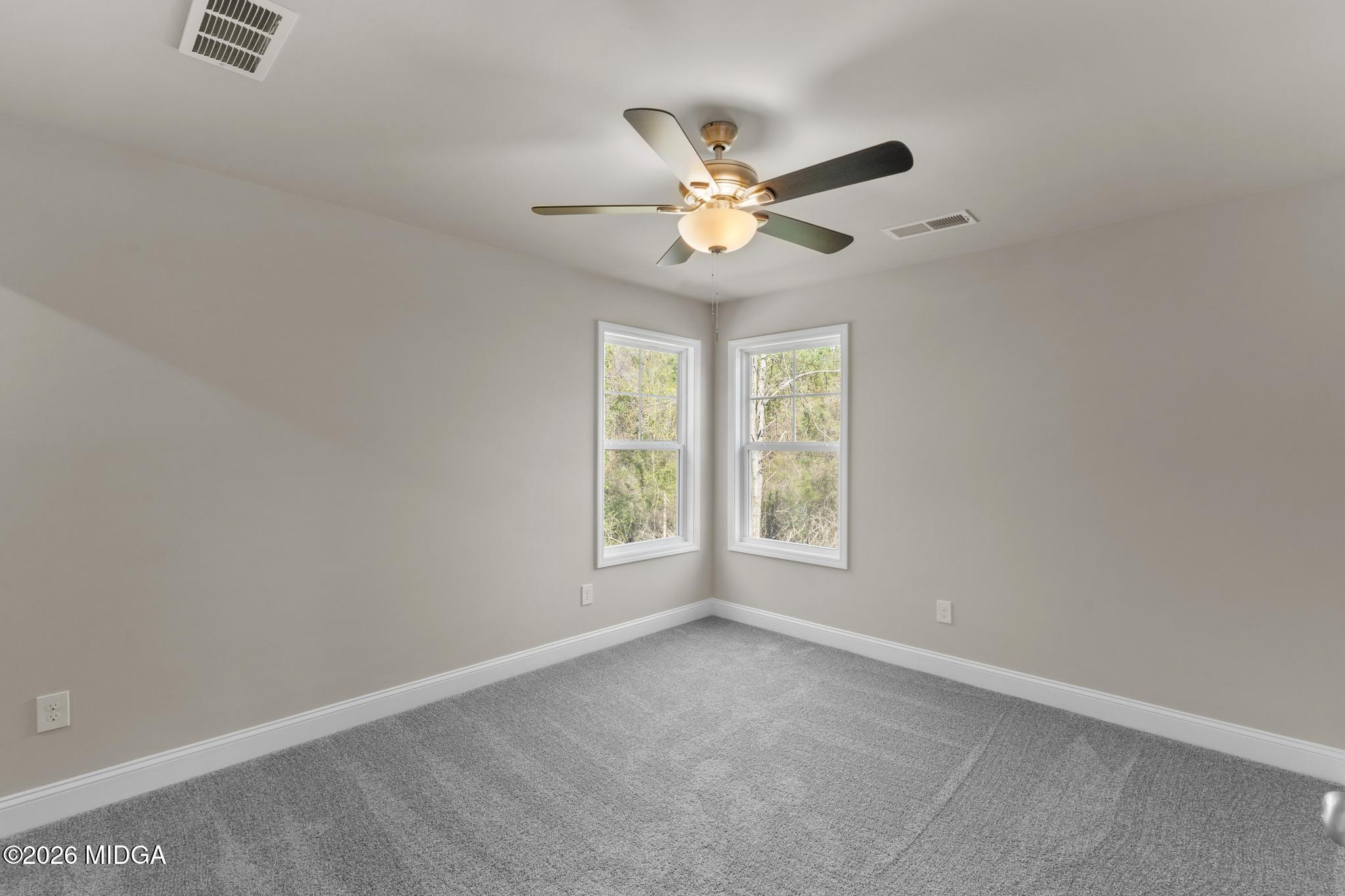 220 Welsh Trail Macon, GA 31216 - Photo 19 of 30 an empty room with windows and fan