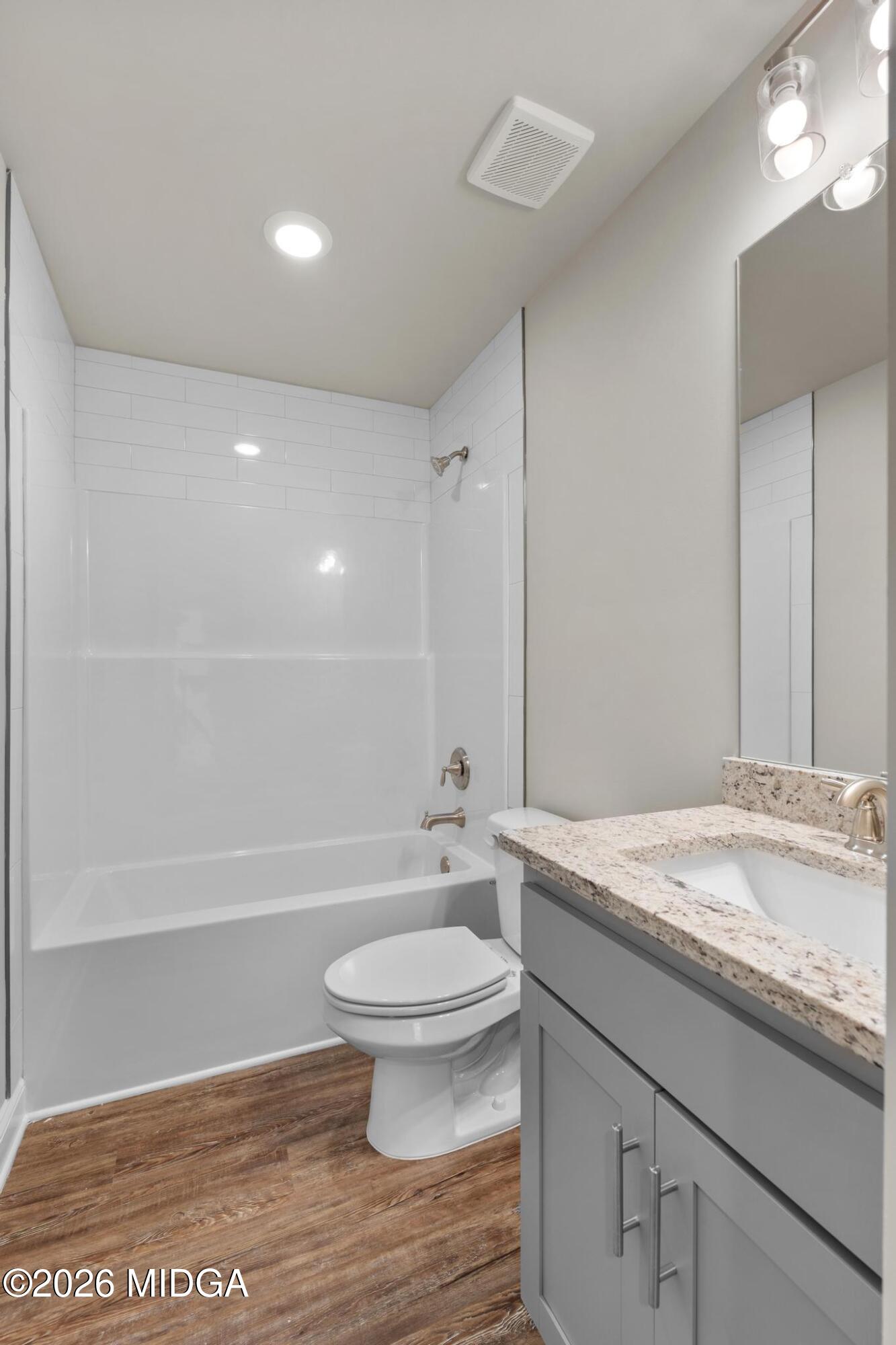 220 Welsh Trail Macon, GA 31216 - Photo 25 of 30 a bathroom with a granite countertop sink a toilet a mirror and bathtub
