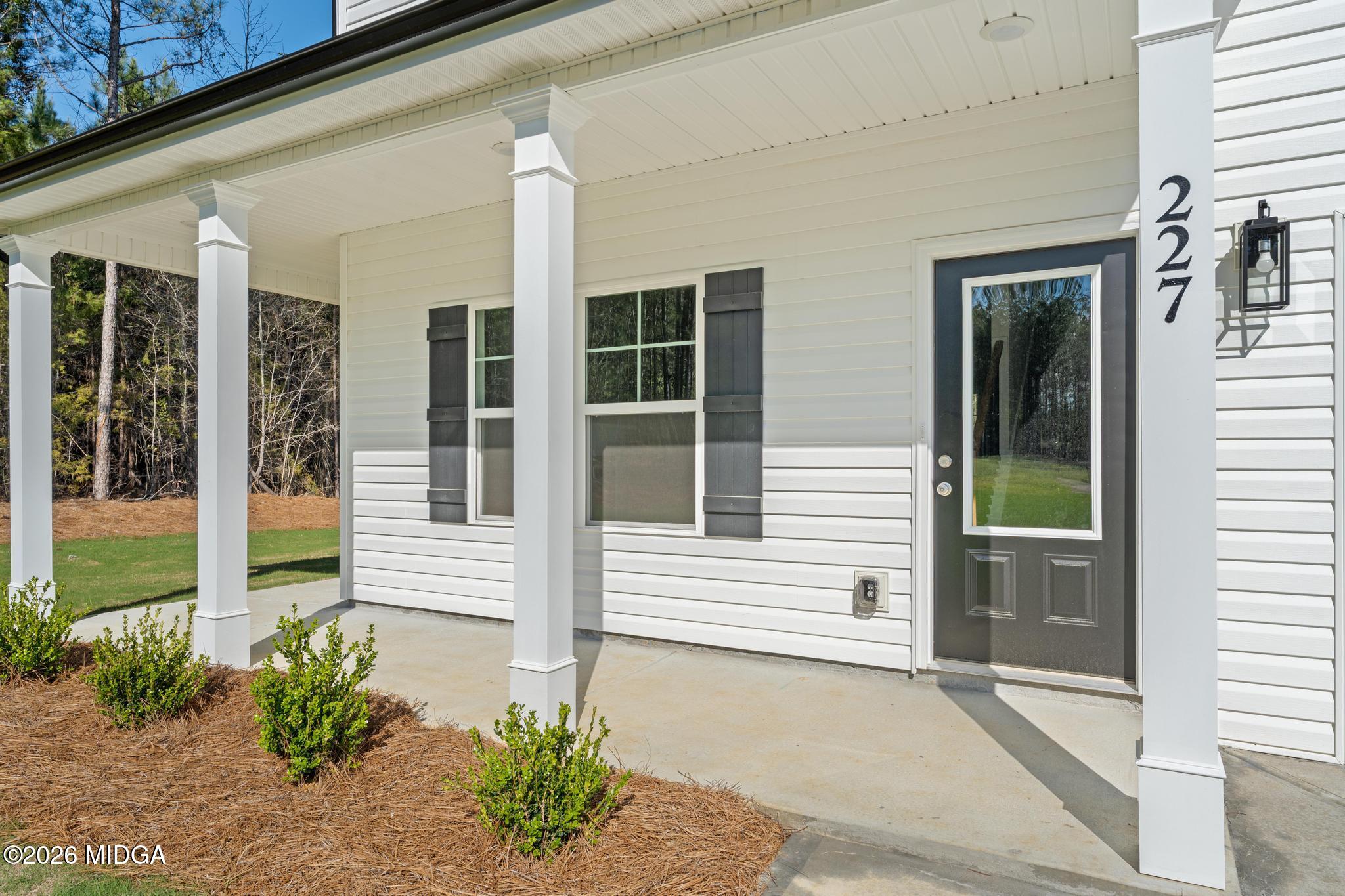 220 Welsh Trail Macon, GA 31216 - Photo 3 of 30 a front view of a house with a large window and potted plants