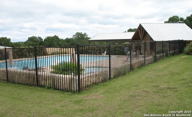 a view of a wooden fence next to a yard