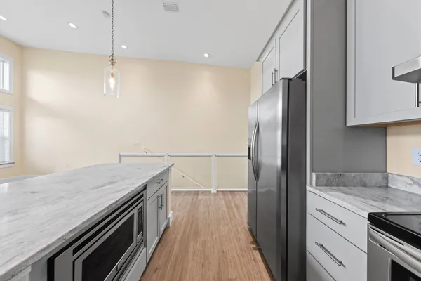 a view of a kitchen with wooden floor and a sink