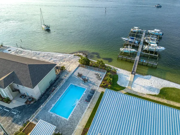 an aerial view of a house a yard and lake view