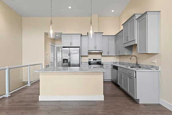a kitchen with a refrigerator a sink and a stove