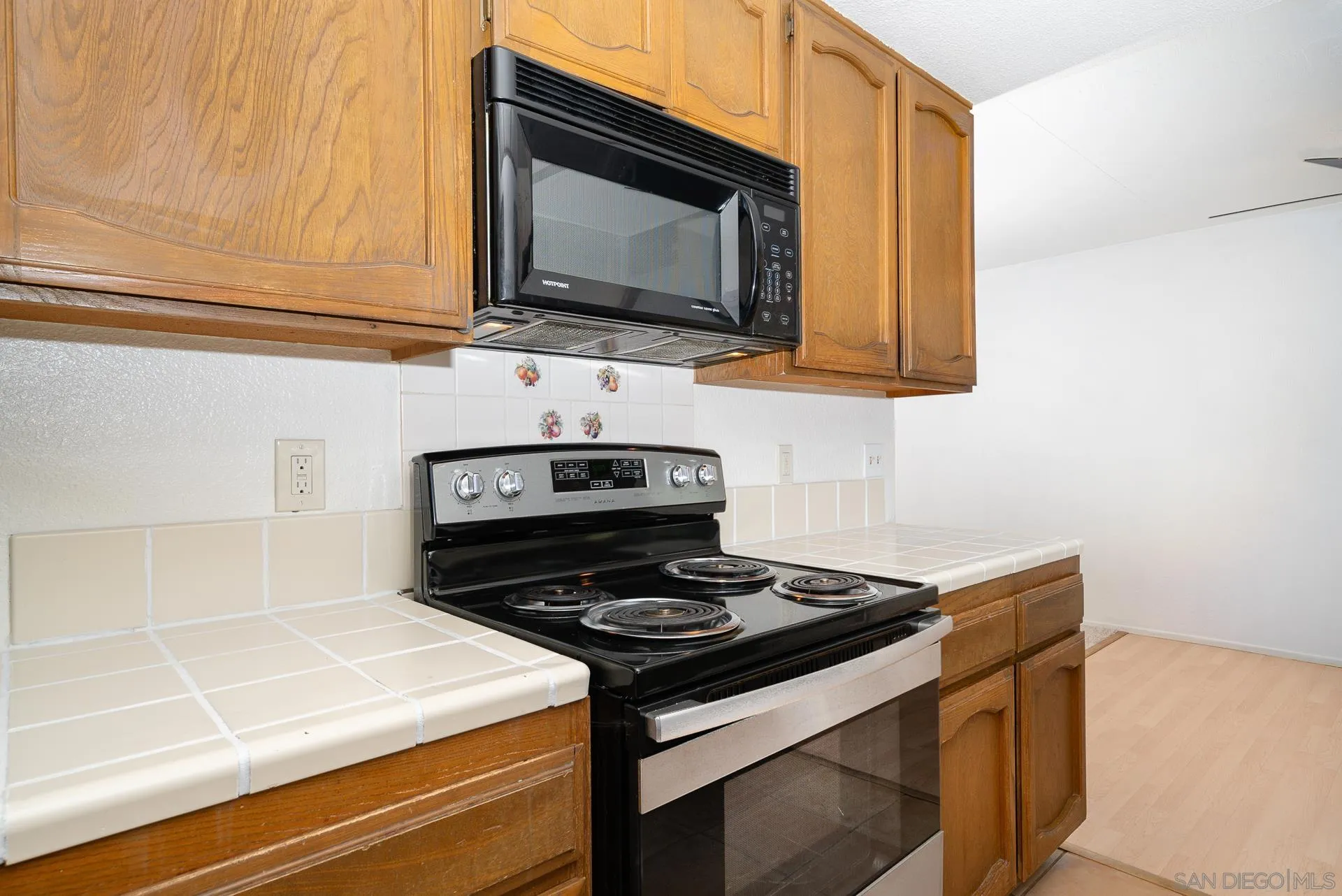 10134 Princess Joann Road Santee, CA 92071 - Photo 13 of 29 a kitchen with stainless steel appliances a stove a microwave and cabinets