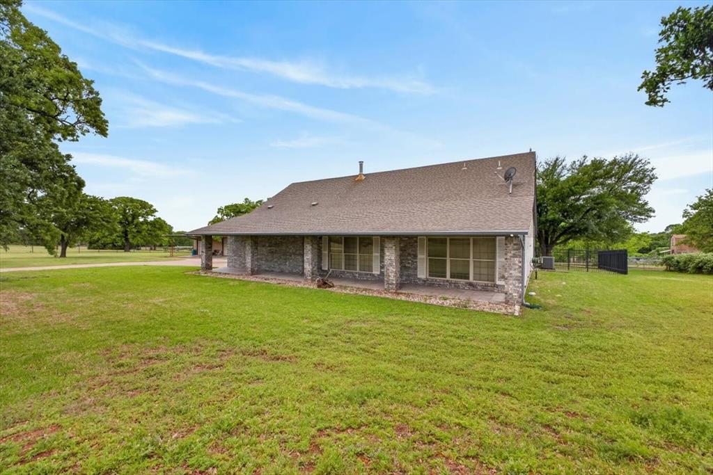 4609 Slayton Road Cleburne, TX 76031 - Photo 5 of 40 a front view of a house with a garden