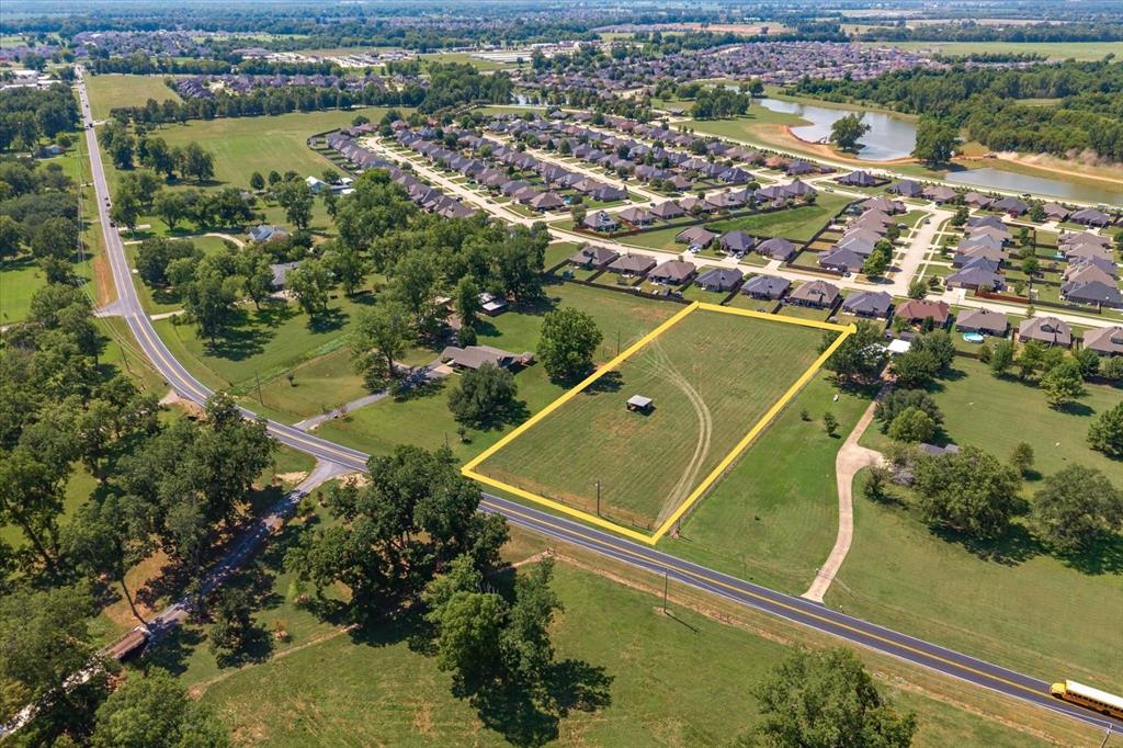 an aerial view of a residential houses with outdoor space and river