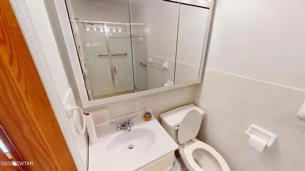 a bathroom with a glass shower door