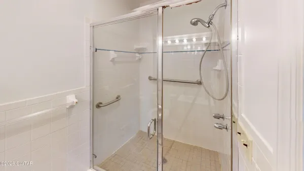a bathroom with a bathtub and shower