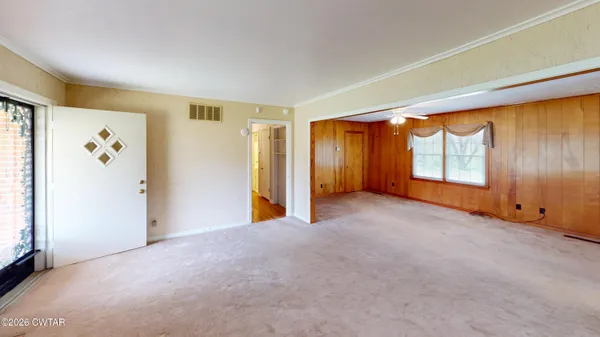 a view of an empty room with a window
