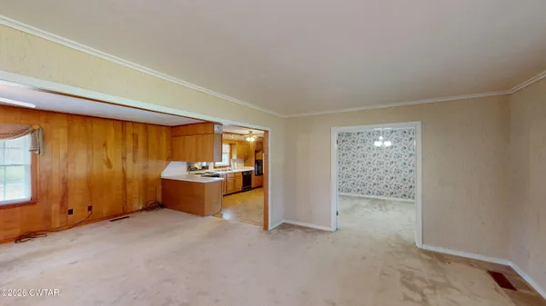 a view of an empty room and a window