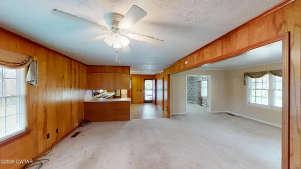 a view of an empty room with a kitchen