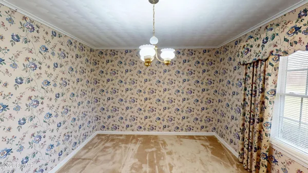 a view of a hallway with a chandelier fan and wooden floor